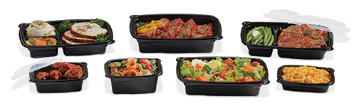 Assortment of prepared meals in black trays, including vegetables, pasta, rice, meat, and side dishes