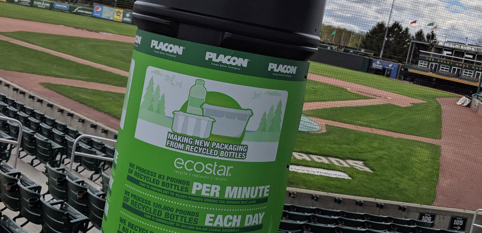 Green recycling bin at a baseball stadium promotes making new packaging from recycled bottles