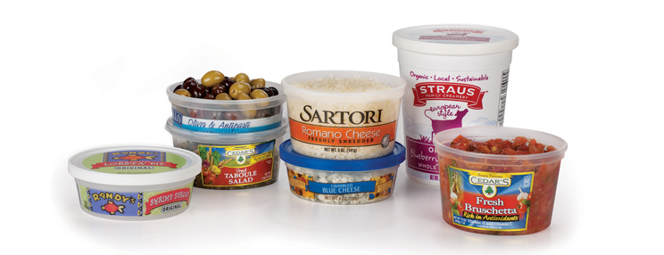 Assortment of packaged foods, including cheeses, olives, tabbouleh, yogurt, blueberries, and bruschetta