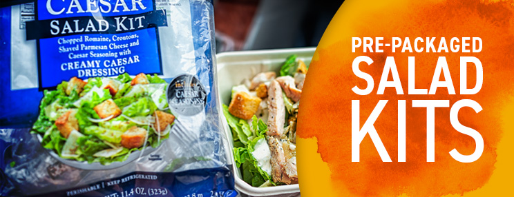Pre-packaged salad kits, including a Caesar salad kit and prepared salad