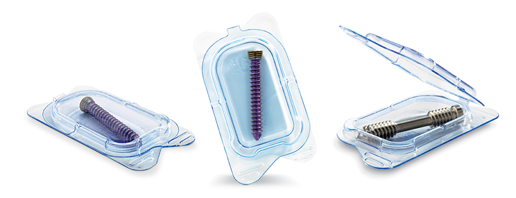 Three transparent packages containing threaded surgical implants, with a pair of forceps shown above the right package
