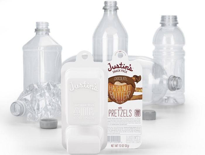 Justin’s Snack Pack chocolate hazelnut butter blend with pretzels, displayed beside empty plastic bottles