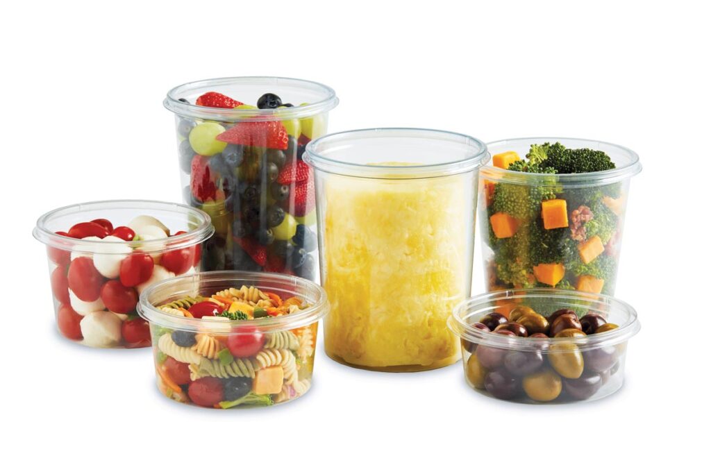 Clear containers filled with mixed fruit, pineapple, vegetables, pasta salad, tomatoes and mozzarella, and olives