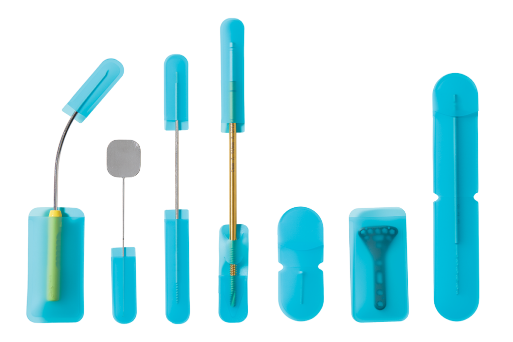 Dental instruments and blue protective cases displayed against a white background